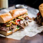 Italian beef sandwich on a wooden board for lunch for people who budget and think and talk about money
