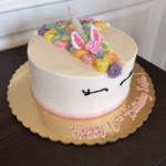 Rainbow Unicorn birthday cake symbolizing that too much of a good thing can be bad, like using credit responsibly.