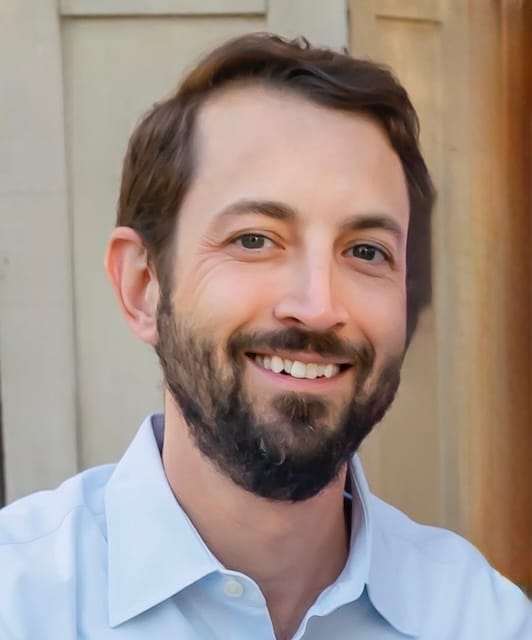 Matthew Adair, founder of Think and Talk Money, smiling as he teaches financial freedom and personal finance to lawyers and professionals.