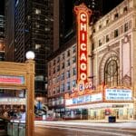 The famous Chicago theater shot with a long exposure at night, right across the street from the redline subway stop depicting the new Chicago way to invest early and often to benefit from compound interest.