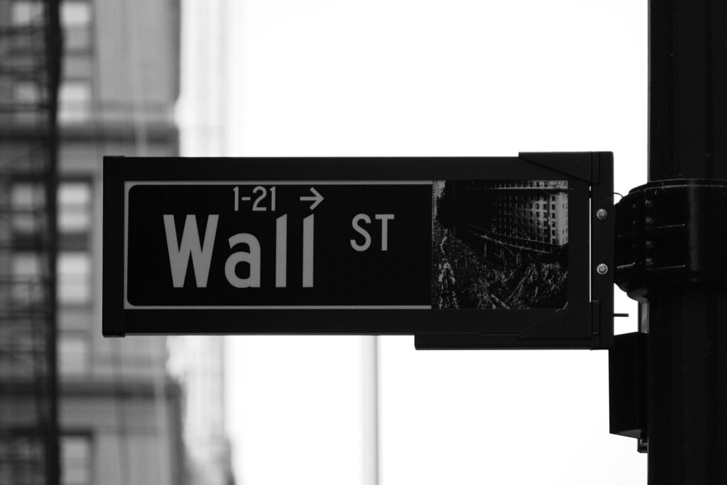 Meet me on Wall St sign which makes it seem like investing is more complicated than it is.