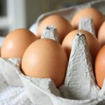 Organic eggs in a basket symbolizing that eggs are the poster child for inflation and that we need to invest to counteract inflation.