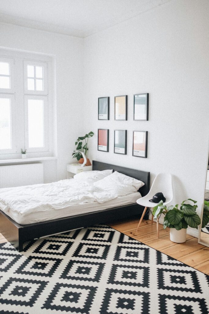 black platform bed wit white mattress inside bedroom of rental apartment where the landlord is getting massive tax benefits.