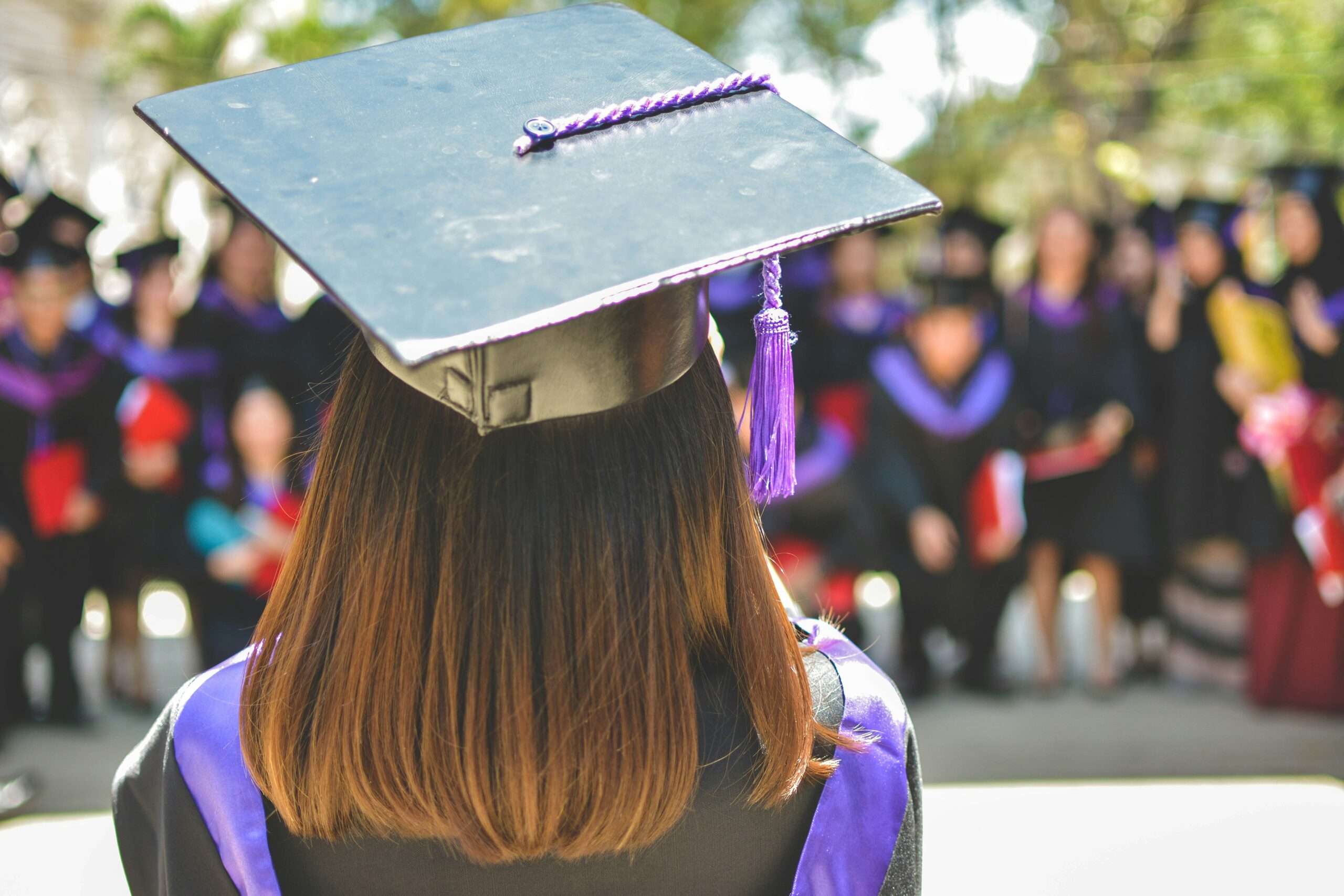 Graduation with woman with purple gown on because her parents saved for retirement and college.