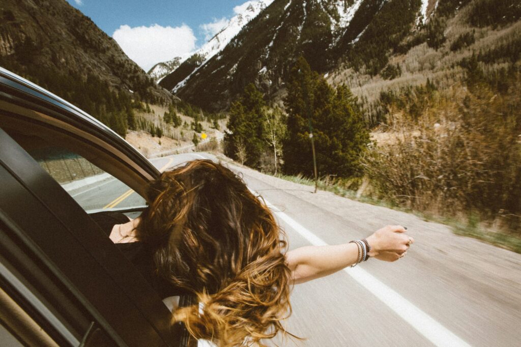 The way to the cabin lady with arm out her window symbolizing what you can do with $10 million in the bank.