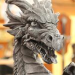 gray dragon statue symbolizing that being good with money does not make you a greedy dragon.