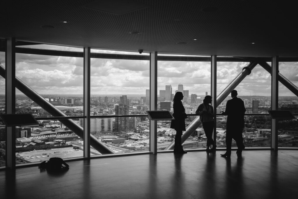 real estate team meeting near a transparent glass indicating the importance of having the right people on your team before you buy rental properties.