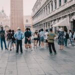Tourist group on Piazza San Marco reflecting the importance of a mortgage broker who acts like a tour guide for rental property investors.
