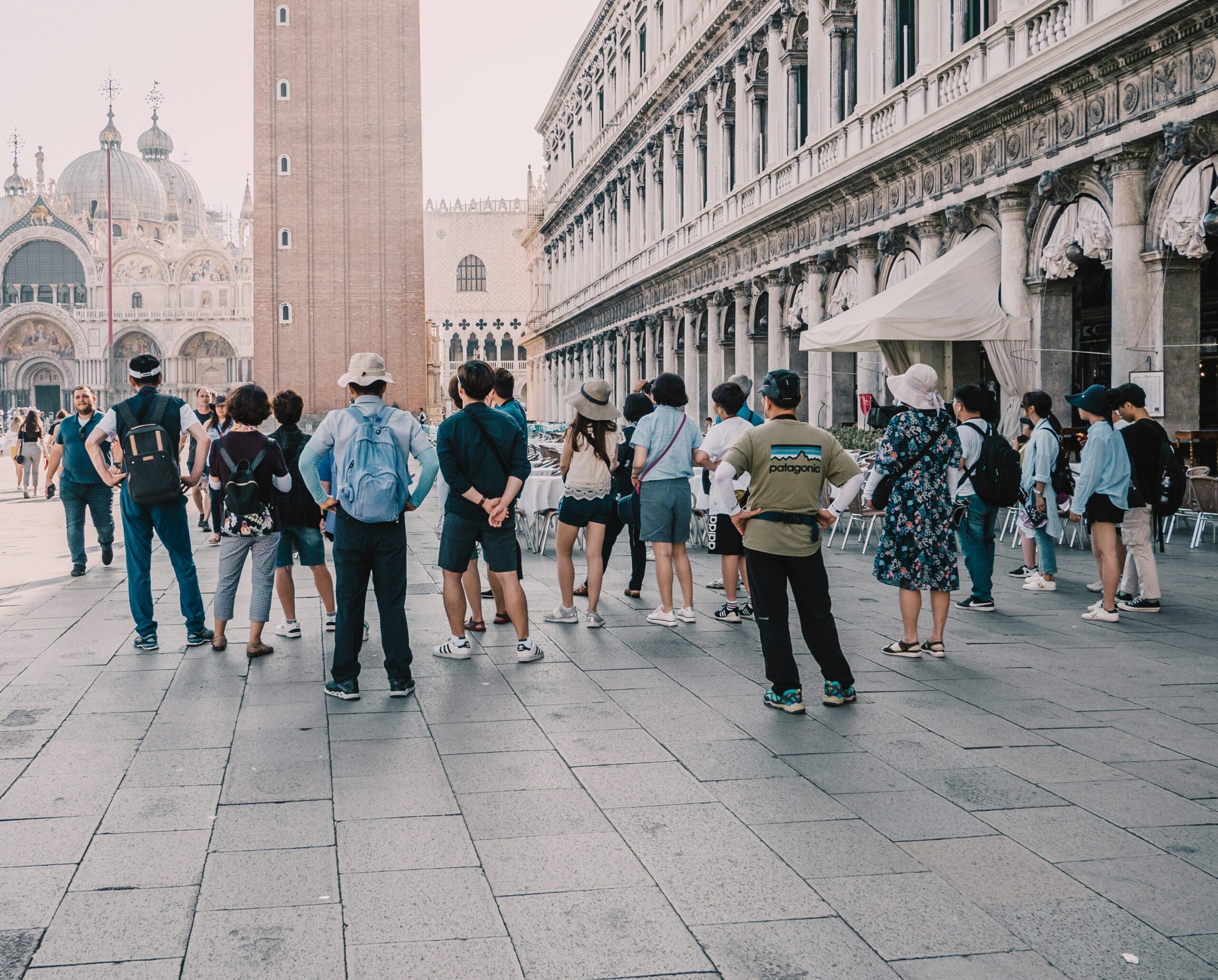 Tourist group on Piazza San Marco reflecting the importance of a mortgage broker who acts like a tour guide for rental property investors.
