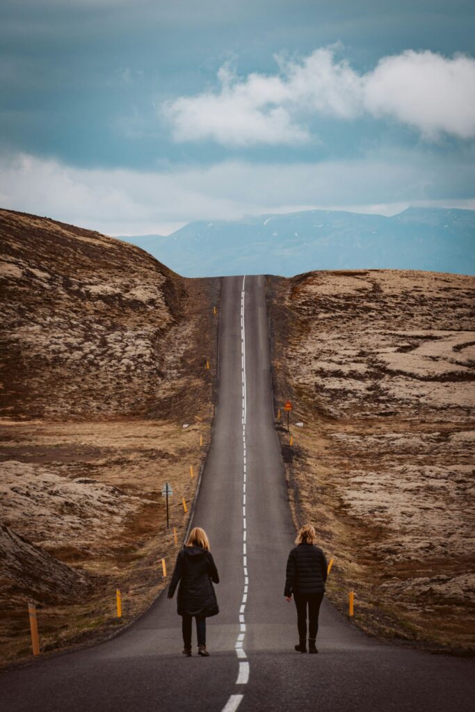 Walking down a remote road near Reykjavik, Iceland indicating that investing in real estate takes a team, the most important person being your spouse or partner.