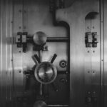 black and silver vault door knob serving as reminder to always evaluate your banking relationships.