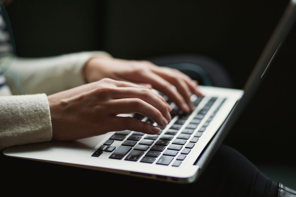 person using laptop to evaluate a rental property using real numbers.