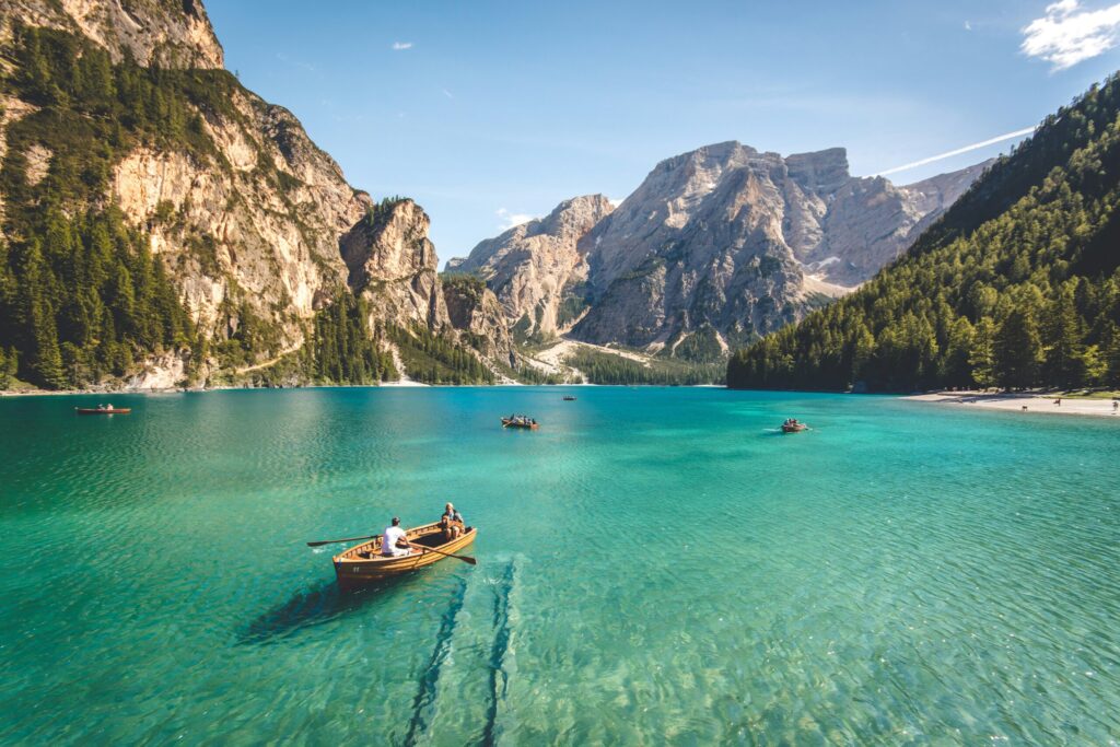 wooden boat on blue lake during daytime indicating what you can do with financial freedom.