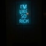 a neon sign that sys I'm like so rich indicating the importance of tracking your net worth.