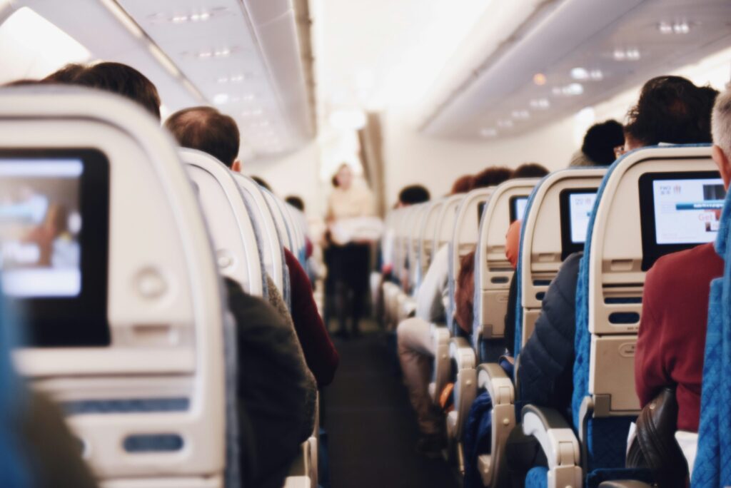 Airplane aisle during flight representing that you should pick one airline that partners well with your credit card.