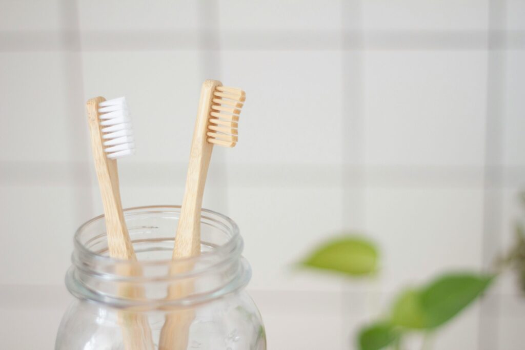Bambu eco toothbrush in a glass bottle symbolizing the morning rush to get out of the house.