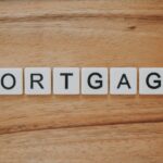 Mortgage spelled out in letters reflecting whether now is the right time to refinance with rates dropping.