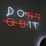 neon sign says don't quit which is a good reminder to landlords when moments get tough.