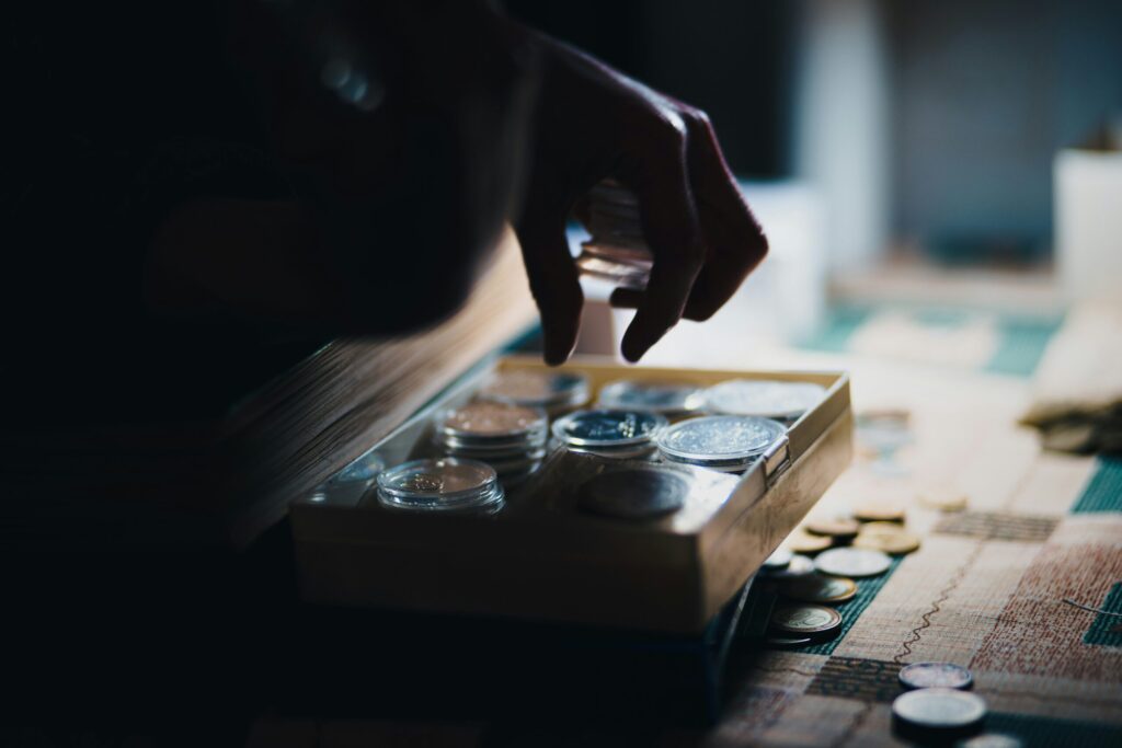 a close up of person playing a board gam ereflecting that the bills still need to be paid when you are furloughed, which is why emergency savings and parachute money are so important.