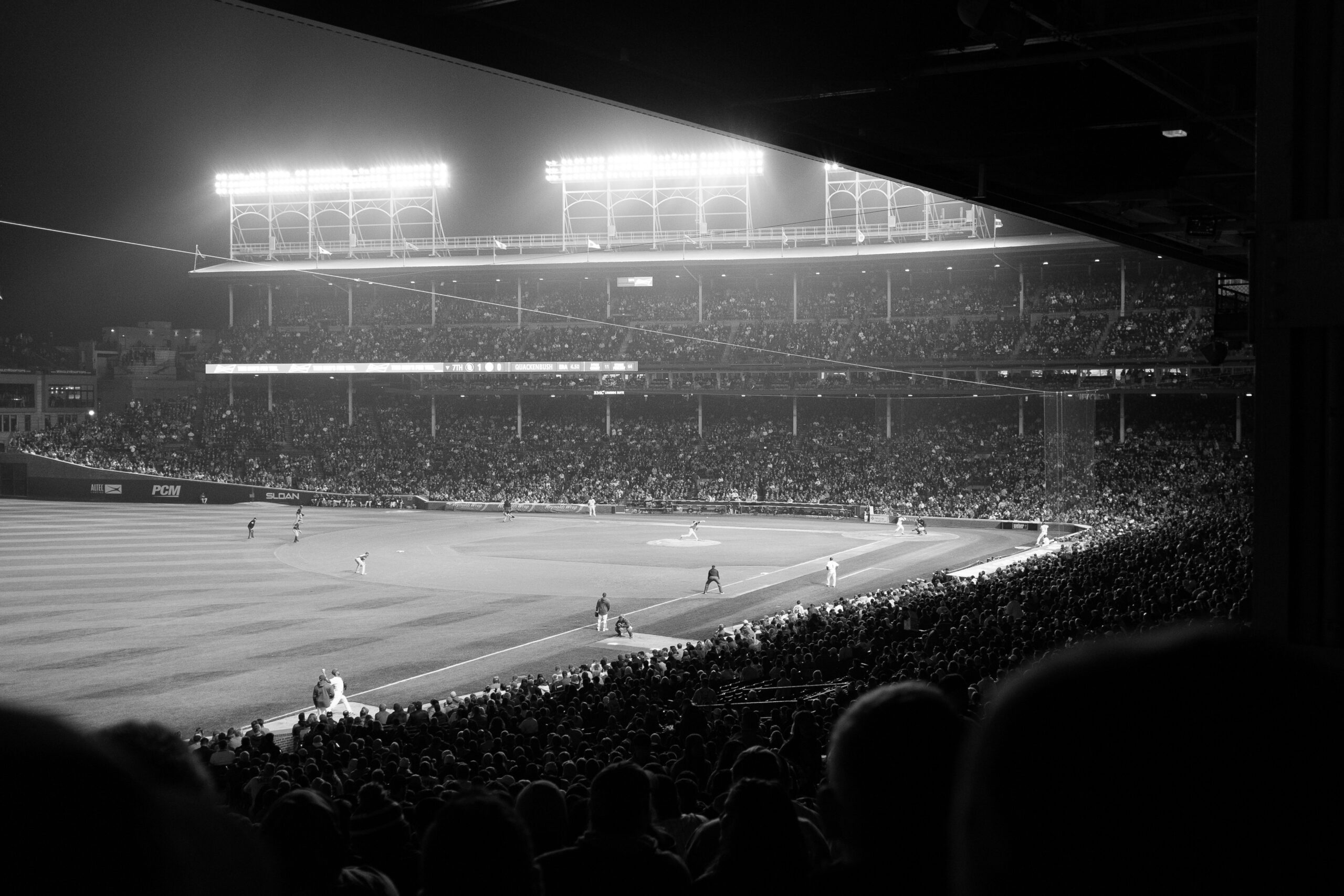 Hazy nighttime Cubs game at Wrigley Field indicating some of the best memories I've had and spent money on.