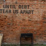 Until debt tear us apart written on a wall indicating how to make a budget to pay off debt.