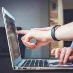 looking at computer to show top 10 tips to pay off debt for lawyers and professionals.