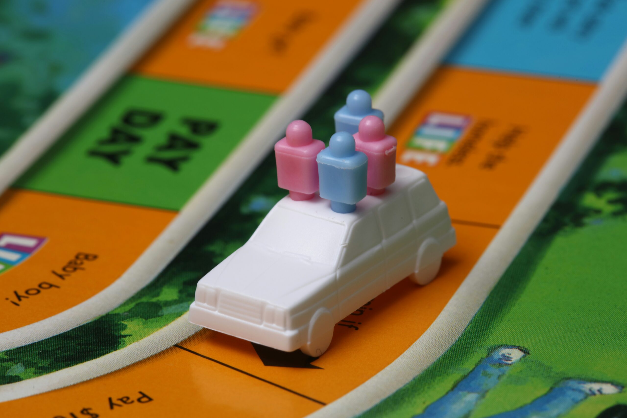 Game of life close-up illustrating that we can turn negative money experiences into positives by playing The Game of Big Expenses.