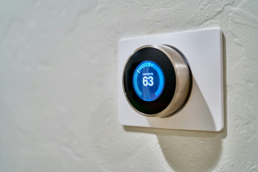 gray nest thermostat displaying 63 indicating that budget busters are the most expected aspect of your budget
