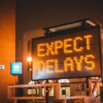road sign says expect delays just as you should expect budget busters will happen and you need to be ready.