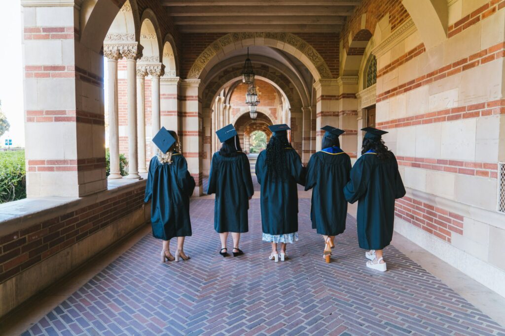 a group of people in graduation gowns reminding us to invest in ourselves.