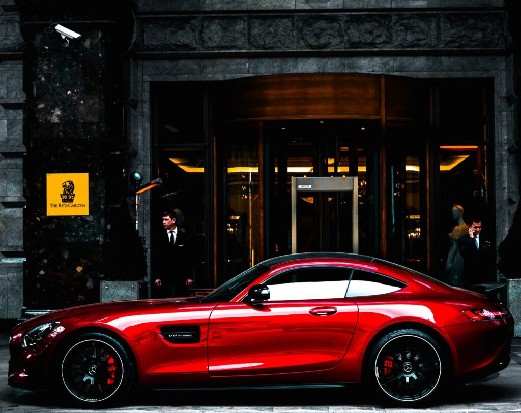 red fancy car representing whether you want to be good with money which means investing in your financial wellness.