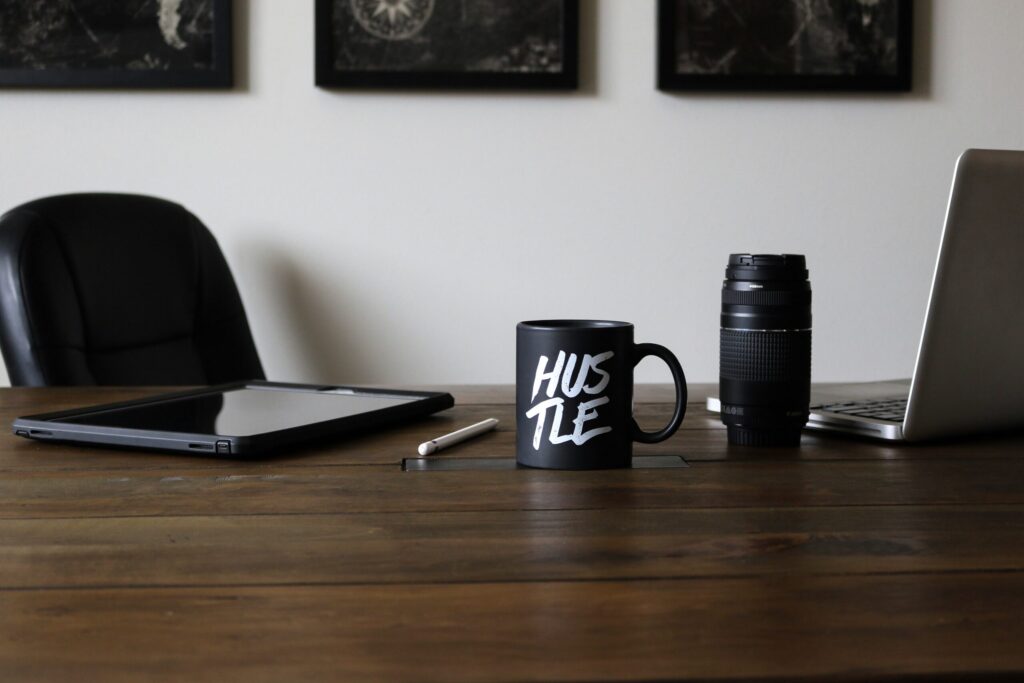 a mug on a desk indicating that we an all have a side hustle to reach financial freedom.