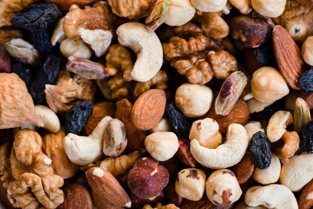 A detailed close-up view of a mixed nuts and dried fruits snack, showing natural textures and colors. Ideal for healthy eating, nutrition, and food background concepts and illustrating why sometimes you gotta spend the money.