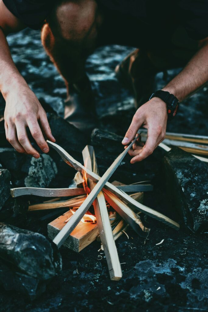 man making a fire indicating that cash is a survival tool. 